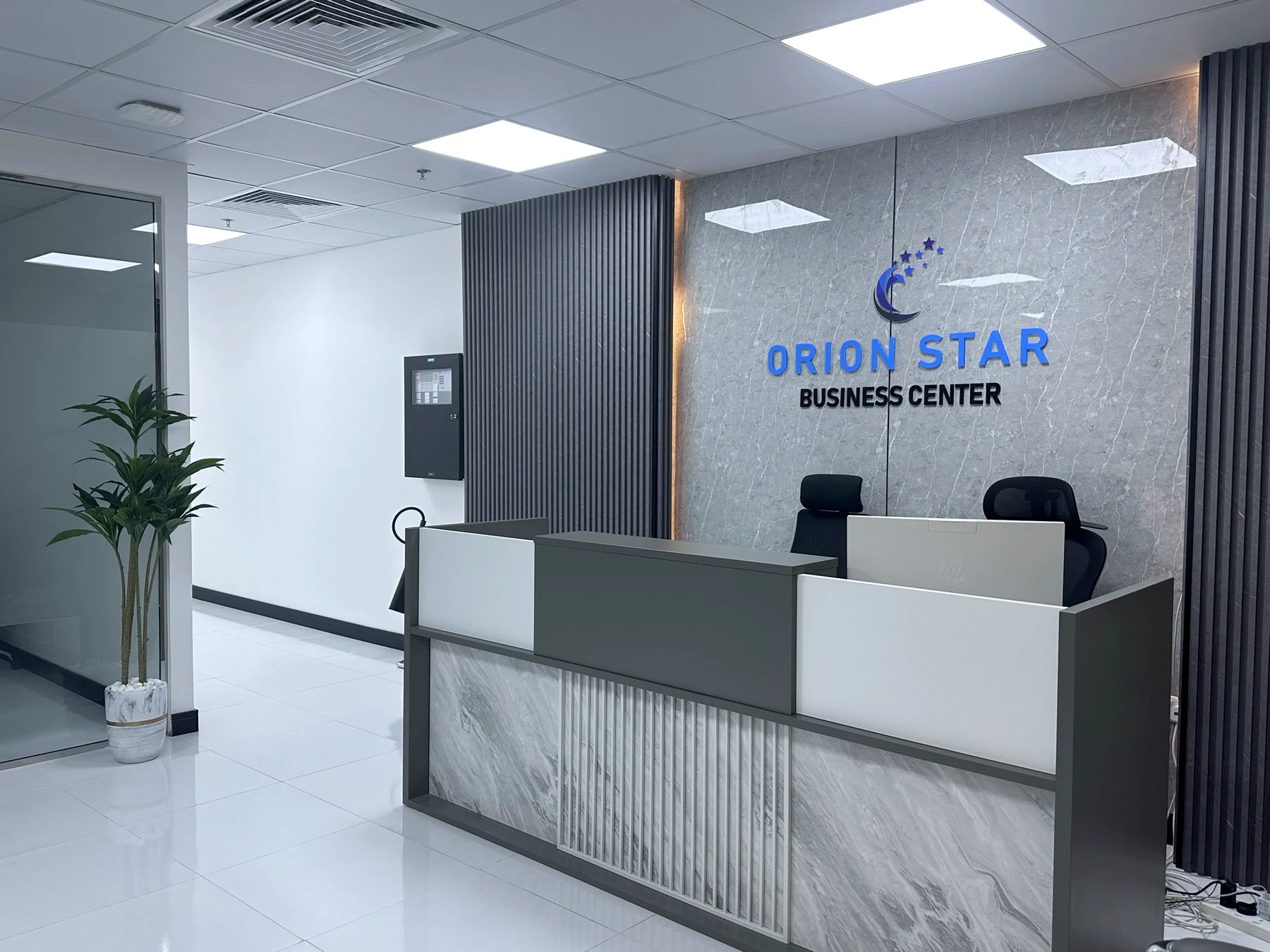 Orion Star reception with marble desk and illuminated brand wall